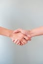 A detailed view of a handshake between two individuals, symbolizing agreement and collaboration.